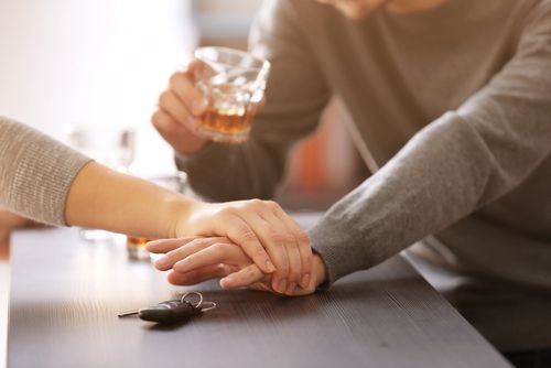 Woman preventing drunk man from taking car keys