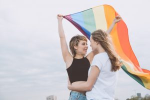 lesbian couple with rainbow flag