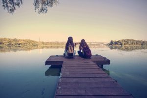 two teenage girls near the lake