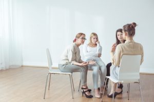 women support group meeting with therapist